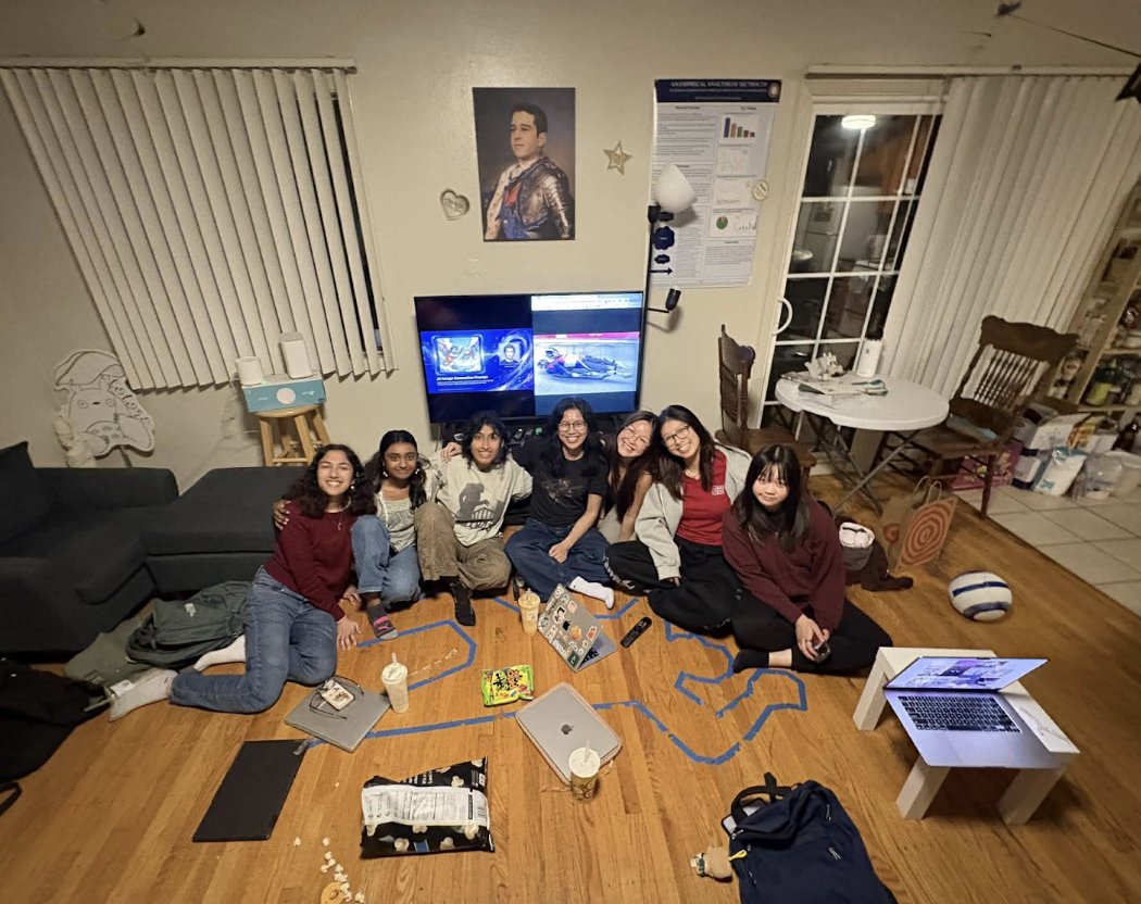 The Sketchpad team sitting together on a living-room floor, laptops around them